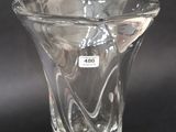 a clear glass vase with a white label on it