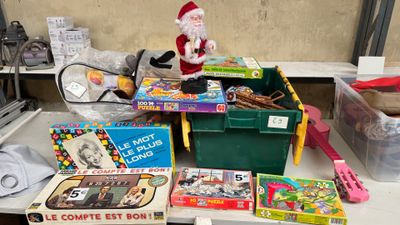 a pile of toys on a table with a santa clause figurine on top of it