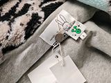 a tag on a pile of clothes with a tag attached to it