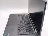 a laptop that is open on a white surface