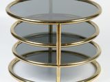 a close up of a table with three glass shelves on it