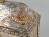 a silver box with a clock on top of it