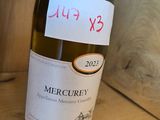 a bottle of wine sitting on a table with a price tag on it