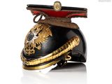 a black helmet with gold decorations on it and a red hat
