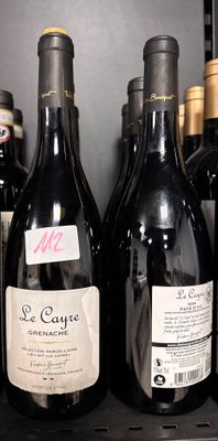 several bottles of wine are lined up on a shelf in a store