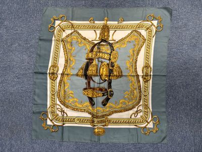 an image of a blue and gold scarf with a picture of a man on a horse