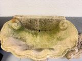 a stone sink sitting on top of a white counter