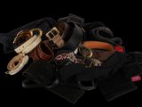 a pile of belts and other accessories on a black background