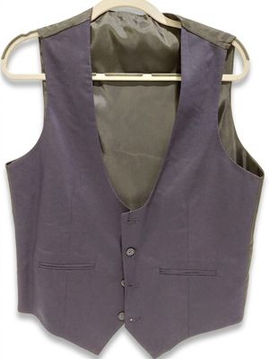 the vest is hanging on a hanger on a white wall