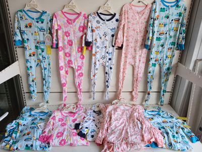 a lot of pajamas hanging on a rack in a room