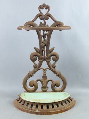 an antique cast iron table with a green marble top