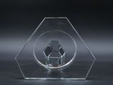 clear glass sculpture of a house in a hexagonal shape