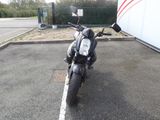 a motorcycle parked in a parking lot next to a building