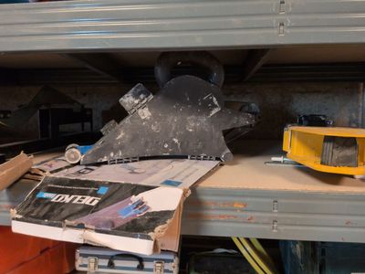 a pile of tools sitting on a shelf in a garage