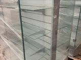 a glass display case in the middle of a warehouse