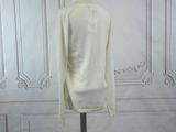 an image of a white sweater on a mannequin stand