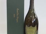 a bottle of champagne sitting next to a green box