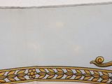 a picture of a gold and white plate with a bird on it