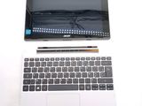 a laptop and a pen sitting next to each other on a table
