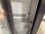 a glass door in the middle of a stainless steel refrigerator