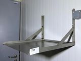 a metal shelf with a sign on it in a room