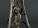 an art nouveau sculpture of a woman holding a snake