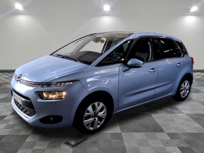 a blue citrole is parked in a room with a checkered floor