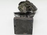 an image of a bronze statue of a woman on a box