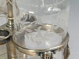 a silver tray with a glass bottle on top of it