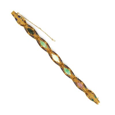 une photo d'un bracelet en or orné de pierres vertes et roses