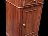 an image of a small wooden cabinet with drawers
