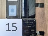 an image of a cell phone sitting on top of a table next to a wallet