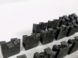 many pieces of metal that are on a white surface