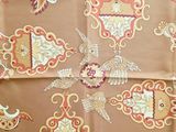 an image of a table cloth with a pattern of birds on it