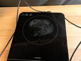 a black stove top with a black burner on top of it
