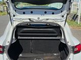 a car with its trunk open on the side of the road