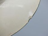 a close up of a white plate with a bird on it