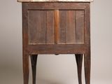 an old wooden side table with a drawer on top of it