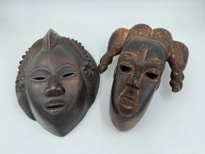 deux masques africains ornés de cornes, placés l'un à côté de l'autre