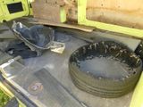 a tire that is sitting in the back of a truck