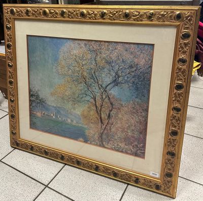 tableau représentant un arbre dans un cadre doré, posé sur un sol carrelé