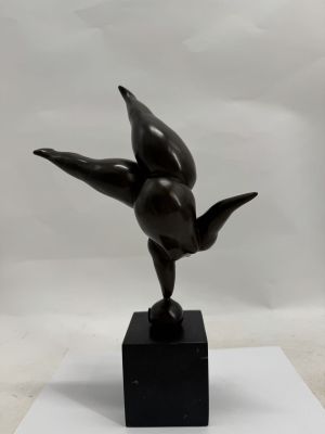 bronze sculpture of a bird on a black marble base