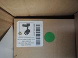 a cardboard box with a green sticker on it