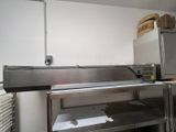 a kitchen with stainless steel counter tops and a microwave