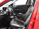 a red car with black leather seats and a steering wheel