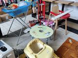 a baby ' s high chair in the middle of a messy room