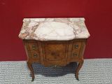 a small table with a marble top in a room