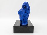 blue sculpture of a fish on a black base