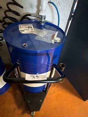 a blue barrel sitting on top of a wooden table