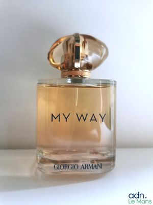 l'image d'un flacon de parfum posé sur une table